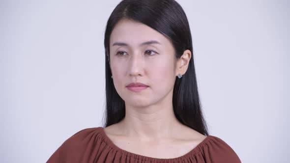 Face of Serious Asian Woman Nodding Head No