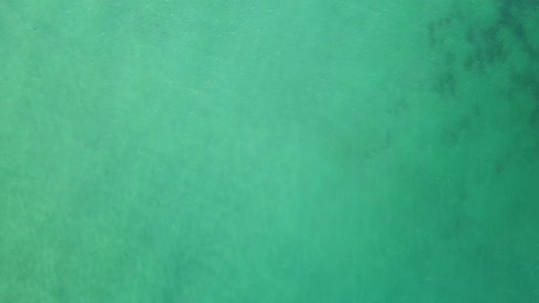 Drone Footage of Green and Blue Ocean Waves Along Shoreline