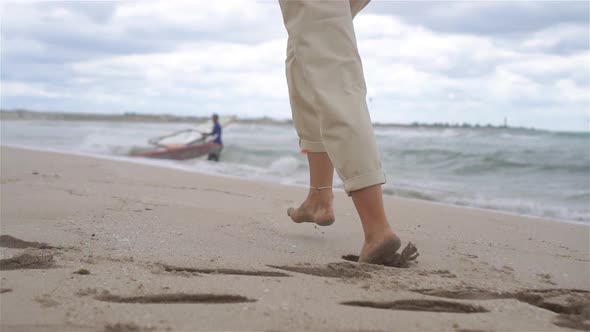 Young Woman on the Beach in the Storm