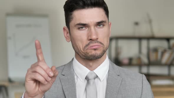 No By Businessman Waving Finger to Reject