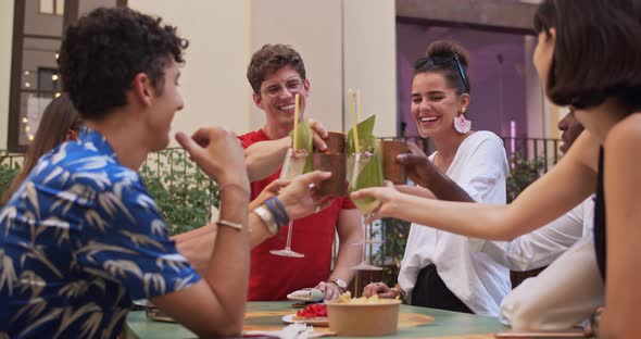 Young students with cocktail glasses toasting