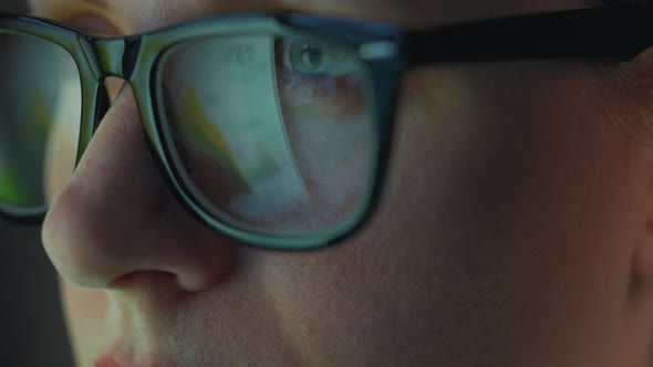 Woman in Glasses Looking on the Monitor and and Working with Charts and Analytics