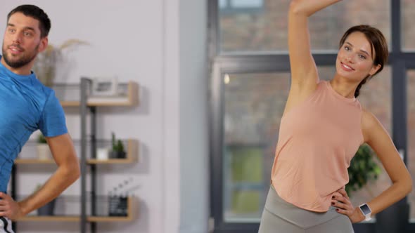 Happy Couple Exercising at Home