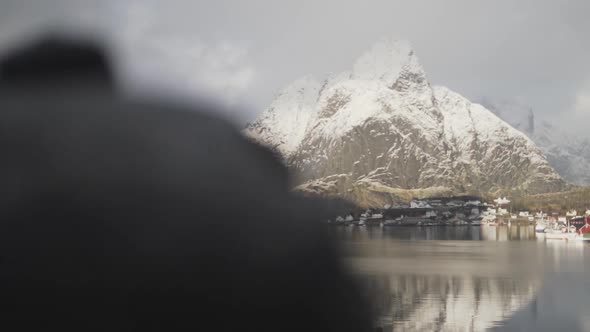 Reine Fishing Village With Snow Covered Mountain