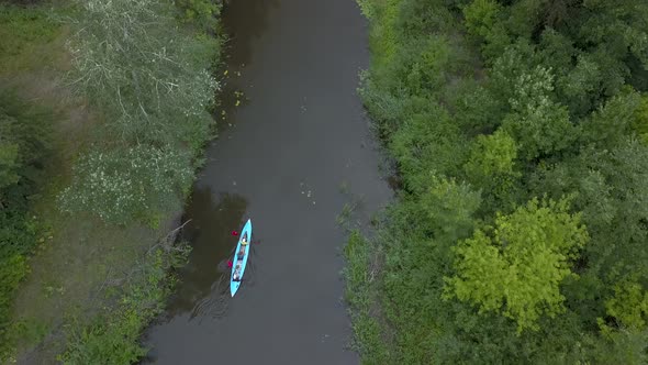 The Kayak Floats Along the River