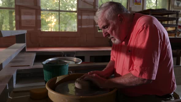 Artist making pottery in a workshop