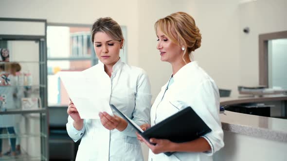 Two Woman Doctors Are Looking at the Results of the Medical Tests