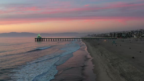 Colorful Sky At Manhattan Beach Pier At Sunset, California, United States - aerial static