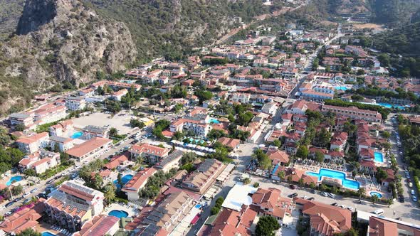 Drone flight close-up over a coastal small town nestled in the mountains of Turkey Mediterranean