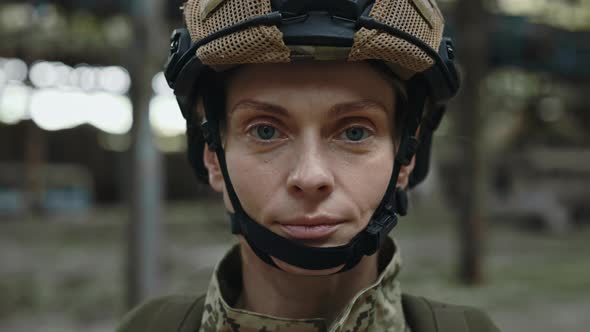 Soldier Looking at Camera with Serious Face on Plant