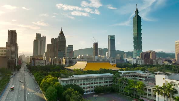 Cinematic aerial shot showing Sun Yat-Sen Memorial Hall and silhouette of skyscraper towers in Taipe