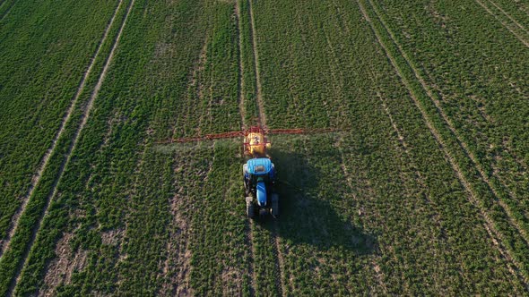 Tractor Spray Fertilizer on Agricultural Field Aerial View