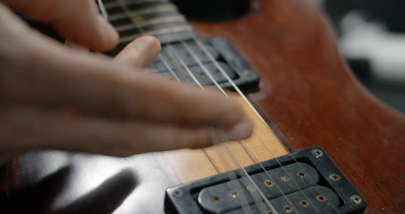 Guitar Tech Cuts the Strings on the Guitar By Nippers in Slow Motion Changing the Strings on the