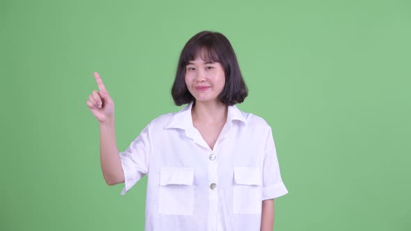 Happy Beautiful Asian Businesswoman Pointing Up