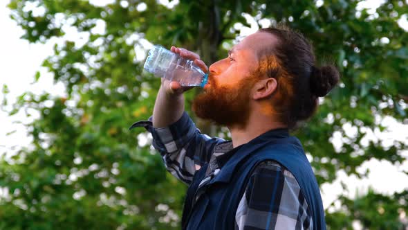 Man Drinking Water In The Park