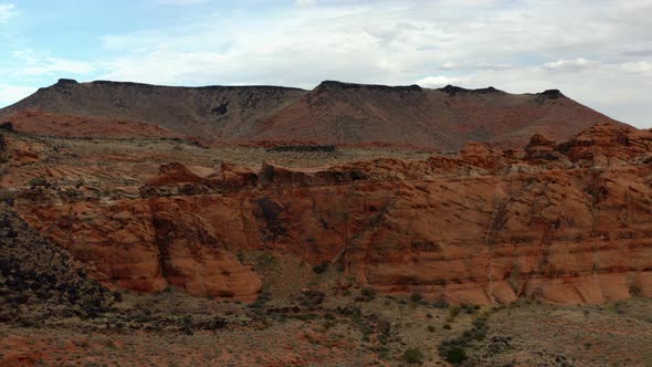 Aerial Drone footage of the mountainous red rocks in southern Utah. Showing the sky, the mountains,