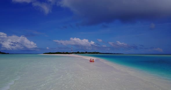 Happy lady and man in love dating on vacation spend quality time on beach on summer white sandy 4K b