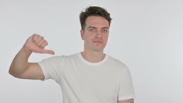 Thumbs Down By Young Man on White Background