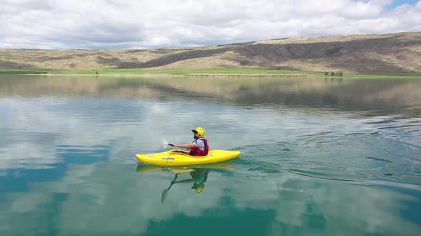 Young Man Canoeing On The Lake Aerial View