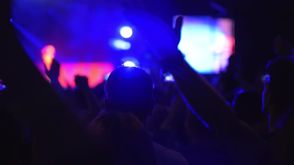 Audience at the concert giving applause to favourite music band