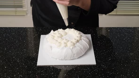 Pastry Chef Fills Cake with Cream Using Pastry Bag