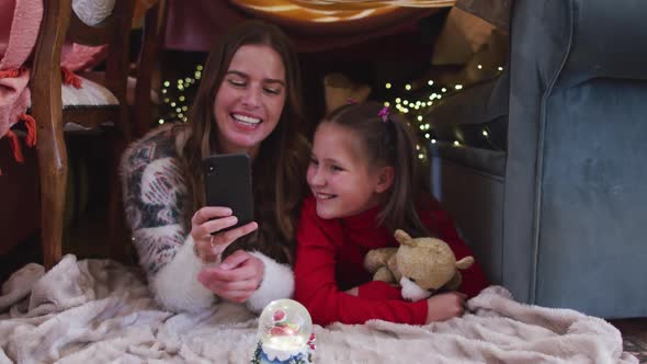 Caucasian mother and daughter taking a selfie on smartphone