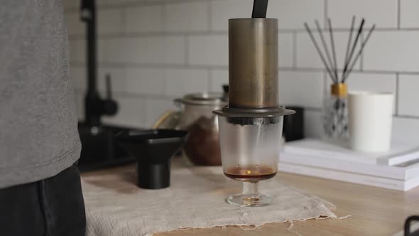 Barista Makes Aeropress Step By Step. Coffee Is Poured By Boiling Water