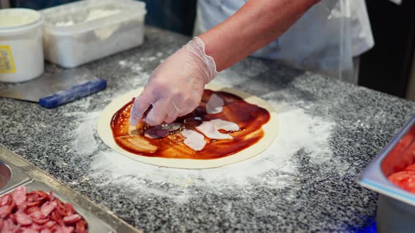 Chef Chef Woman Putting Sausages On Pizza Dough, Putting Toppings On Dough Cooking Process Of Making