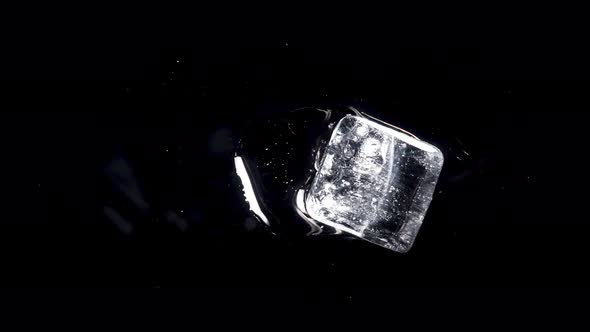 Ice Melts and Rotates on a Black Background