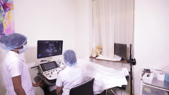 Indian Nurse And Ultrasound Operator Viewing A Fetus