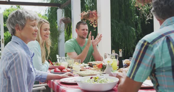 Happy family eating together at table