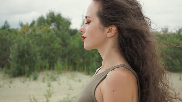 Pretty Woman Touching Hair on Beach