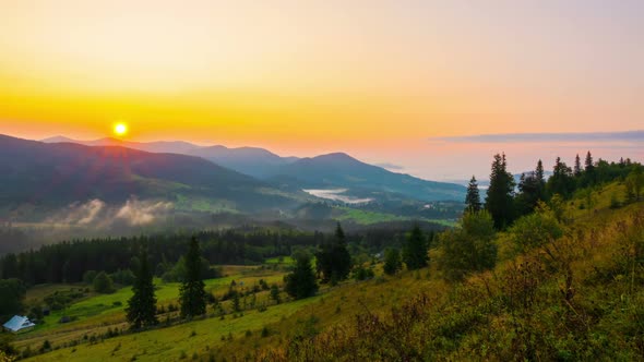 Fantastic Sunrise over the Foggy Summer Mountain