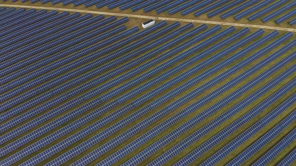 Aerial Drone Shot of Rows of Solar Panels Bisected with a Line