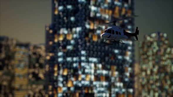 Slow Motion Helicopter Near Skyscrapers at Night alt