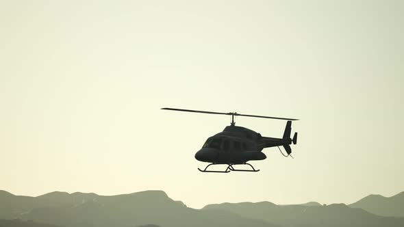 Extreme Slow Motion Flying Helicopter and Sunset Sky