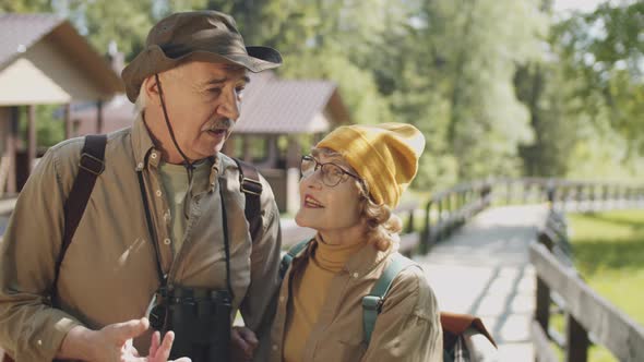 Portrait of Happy Senior Couple on Hike in Park