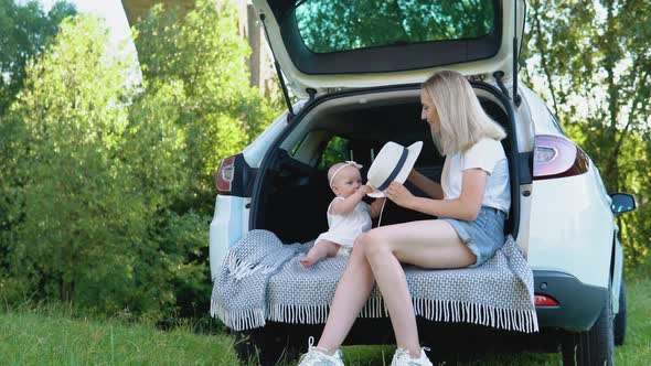 Happy Mother and Stylish Baby Out of Town