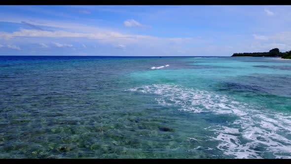 Aerial flying over scenery of perfect lagoon beach adventure by aqua blue water with white sandy bac