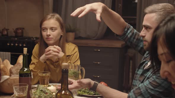 Man Telling Story to Friends at Dinner Party