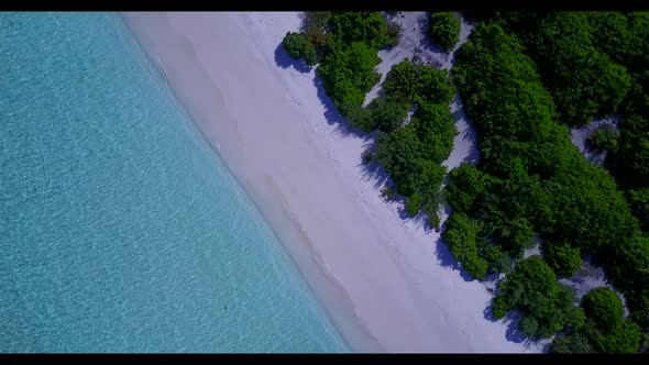 Aerial above seascape of tropical coast beach break by aqua blue sea with bright sandy background of