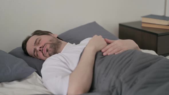 Young Man Unable to Sleep in Bed