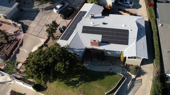 Solar panels on a home rooftop for clean, efficient, renewable energy - aerial descending spinning v
