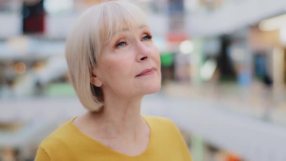 Closeup Mature Caucasian Woman Standing Indoors Looking Up Turns to Camera Female Portrait Happy