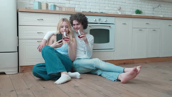 Young Adult Beautiful Caucasian Couple Celebrating Something at Home Take a Selfie on the Phone
