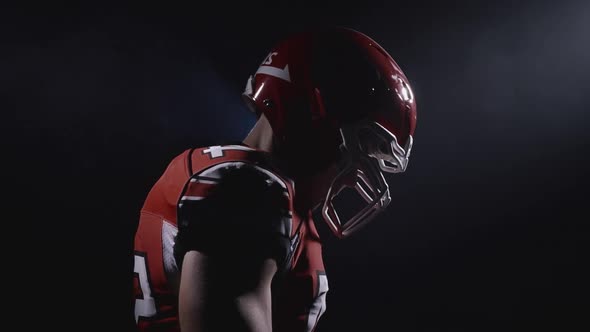 Profile Portrait of Determined Professional American Football Player in Helmet Ready for Game 