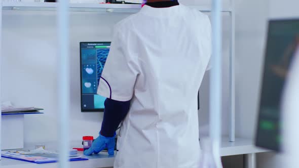 Black Chemist Checking Blood Samples