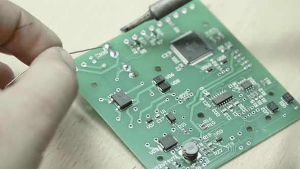 A Worker Is Working on the Creation of an Electronic Board. Close-up.