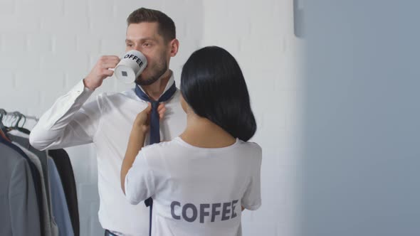 Wife Helping Husband with Tying Necktie in Morning