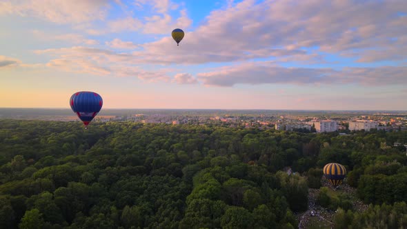 Aerial Drone View of Colorful Hot Air Balloons Flying Over Green Park and River in Small European